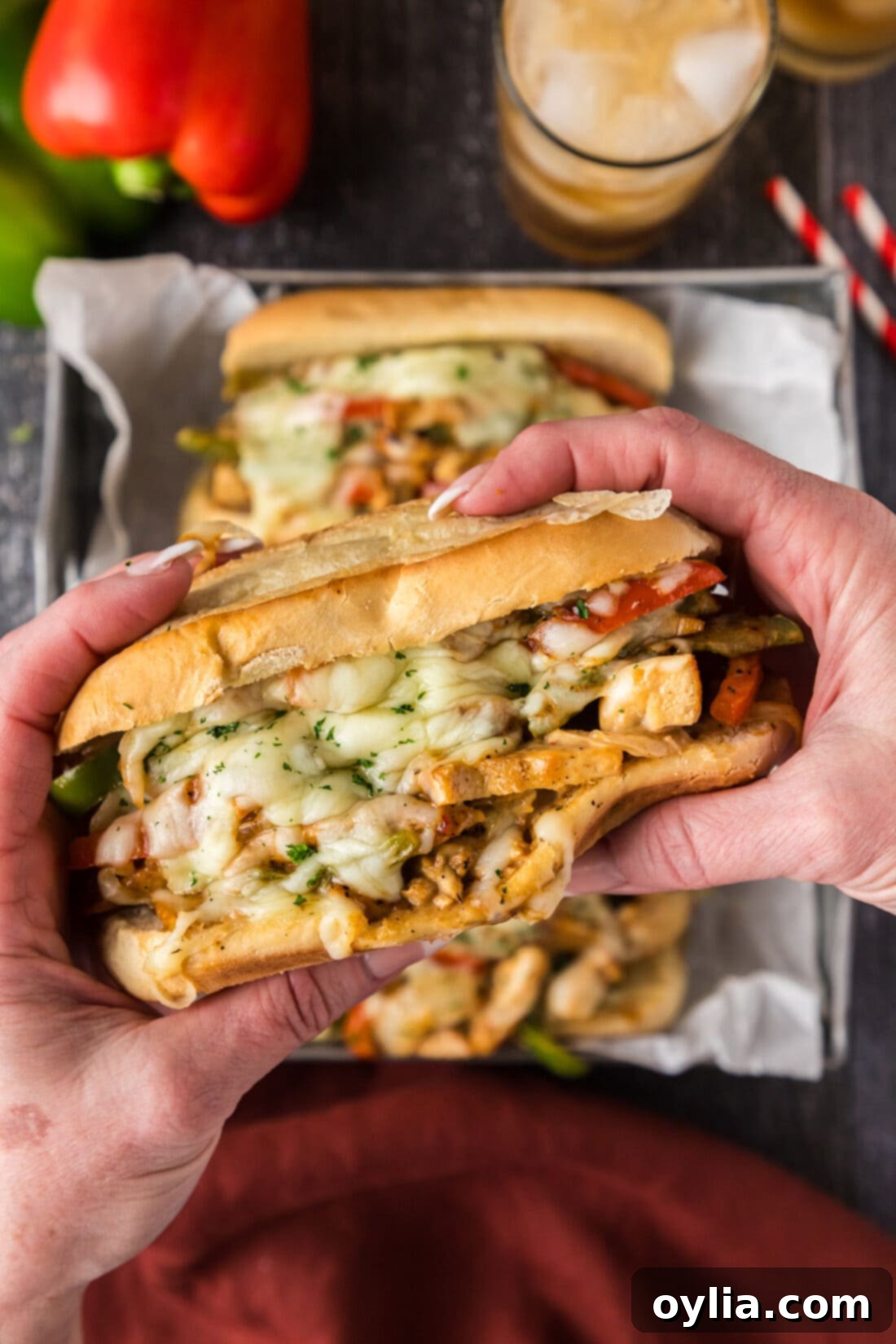 Ultimate Chicken Philly 9 Hands holding a Chicken Philly Cheesesteak