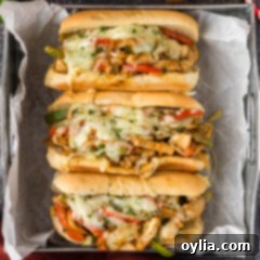 Ultimate Chicken Philly 10 Close up photo of three Chicken Philly Cheesesteaks in a tray