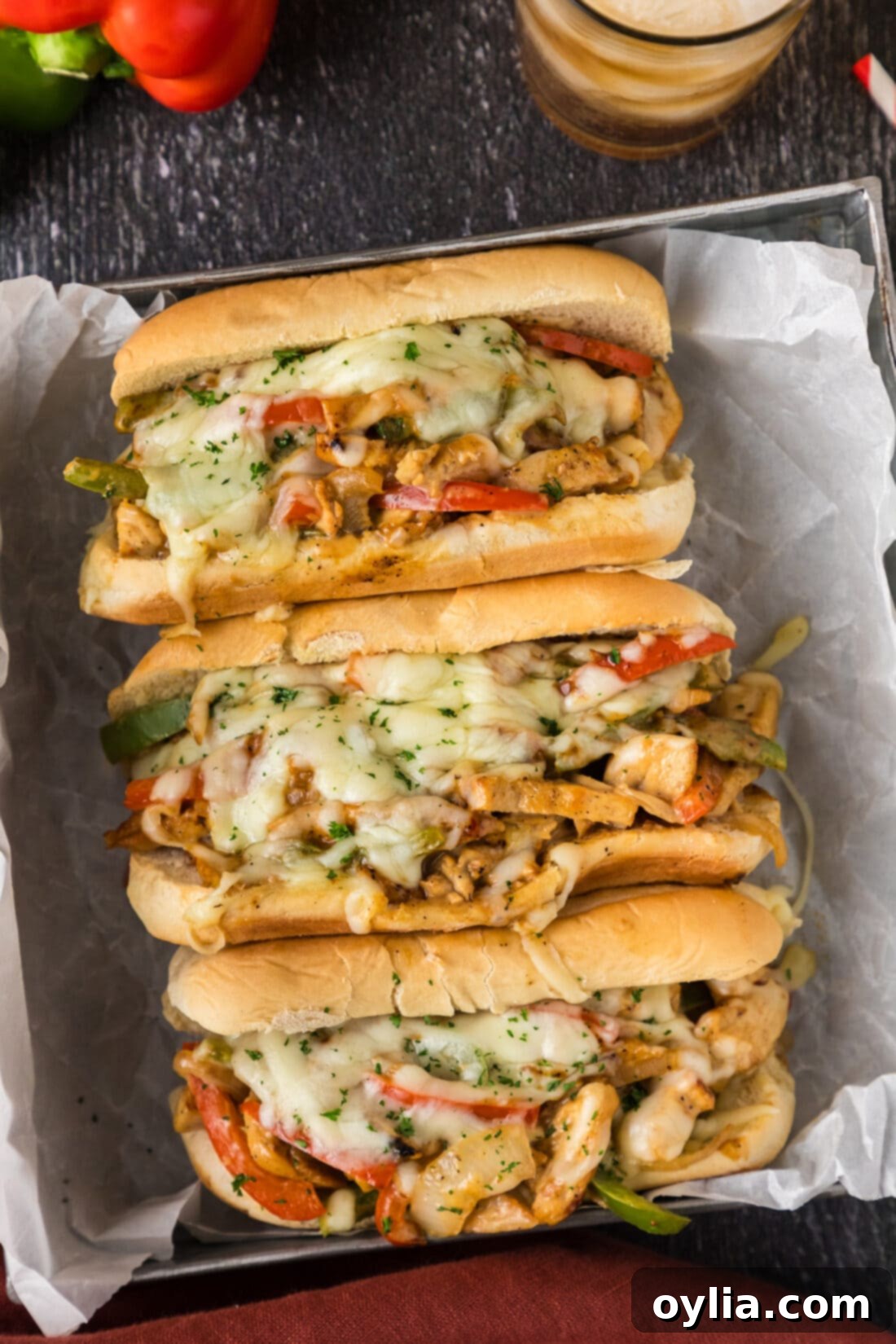 Ultimate Chicken Philly 2 Three Chicken Philly Cheesesteaks in a metal serving tray