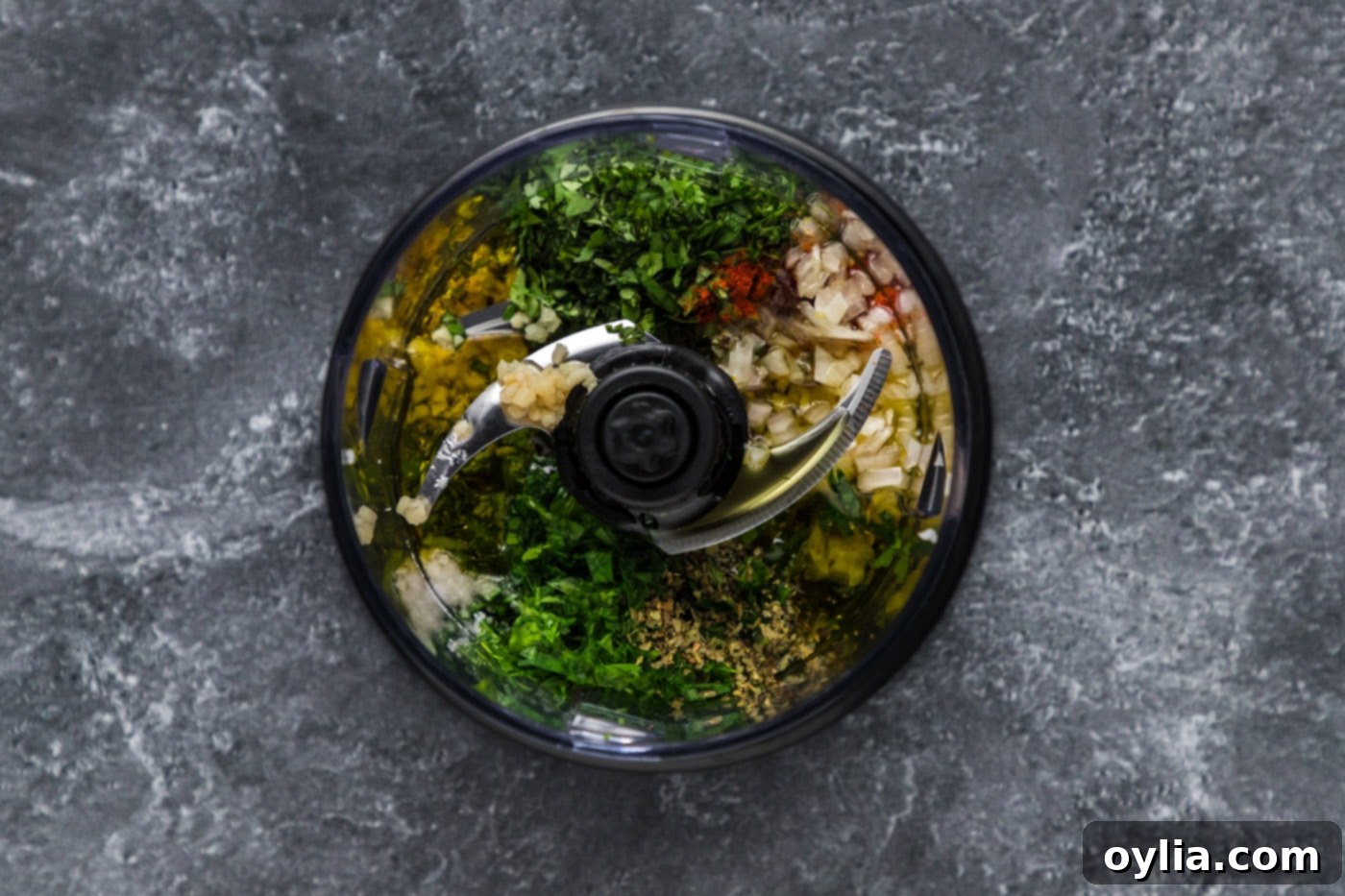 chimichurri ingredients in a mini food processor, before blending
