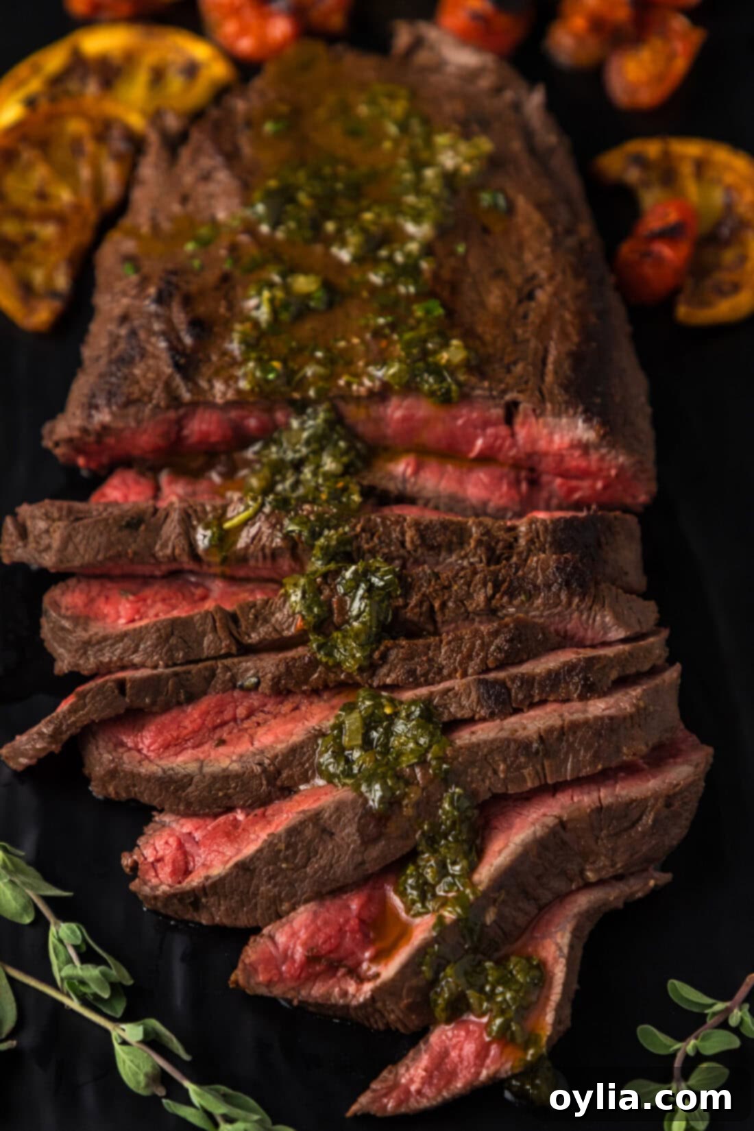 Sliced Flat Iron Steak topped with vibrant Chimichurri sauce