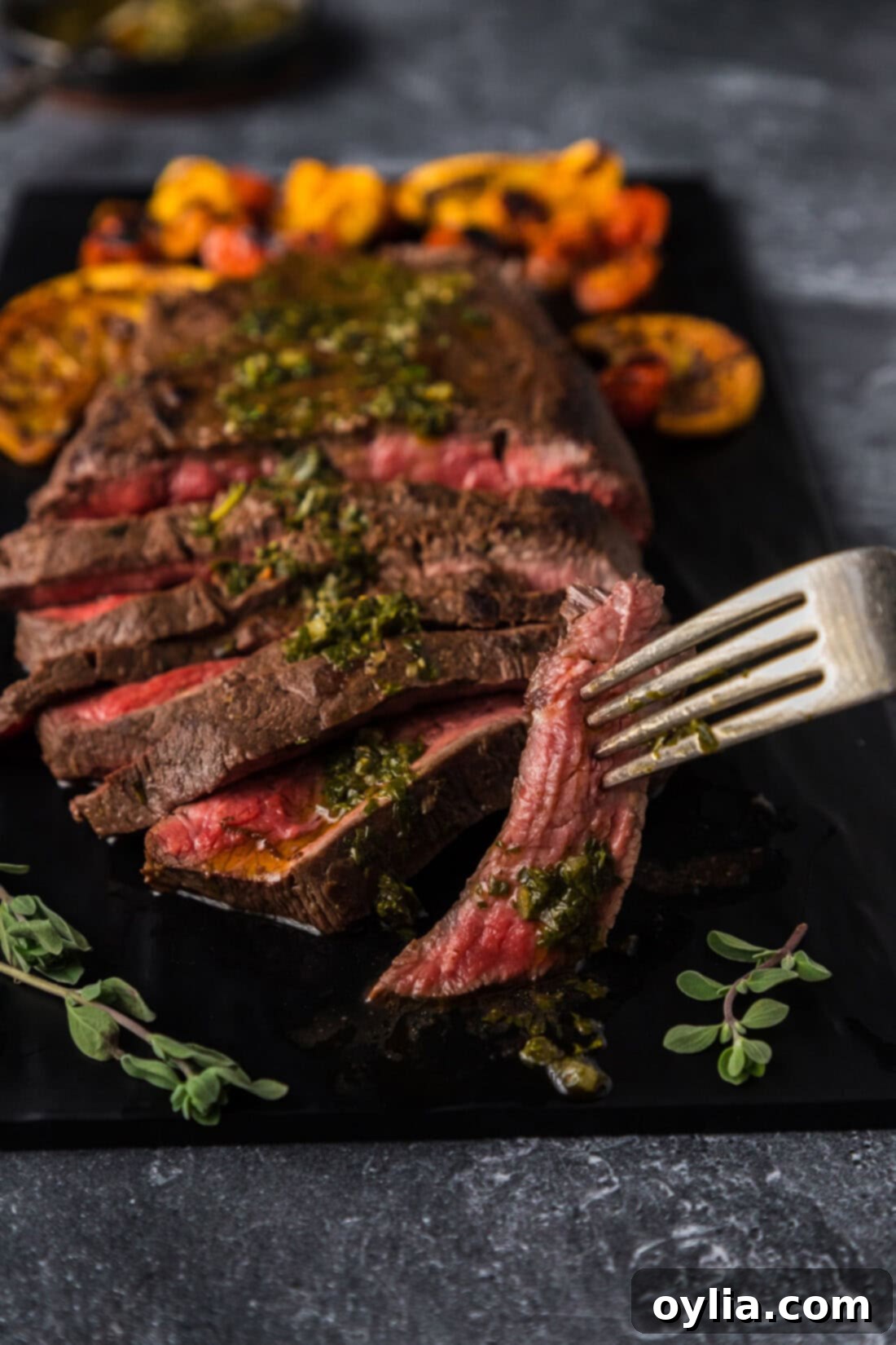Piece of Flat Iron Steak held on a fork, showing its tenderness