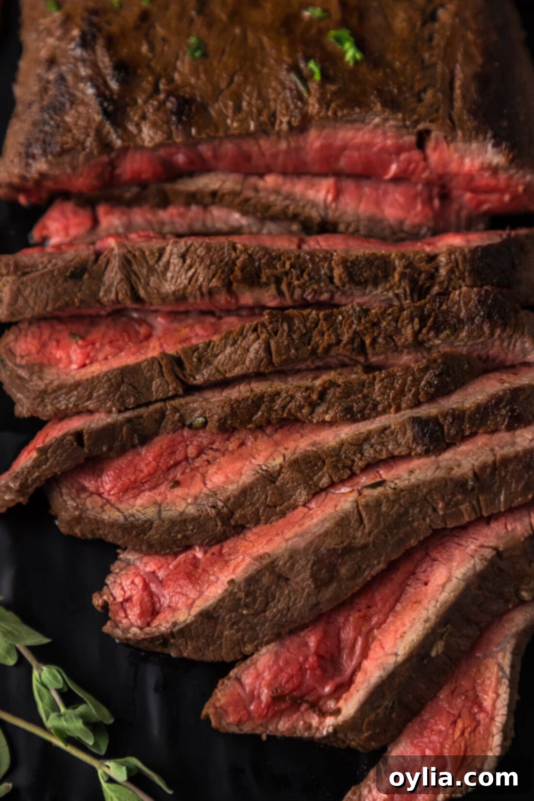 Close up photo of Flat Iron Steak cut into thin, juicy slices