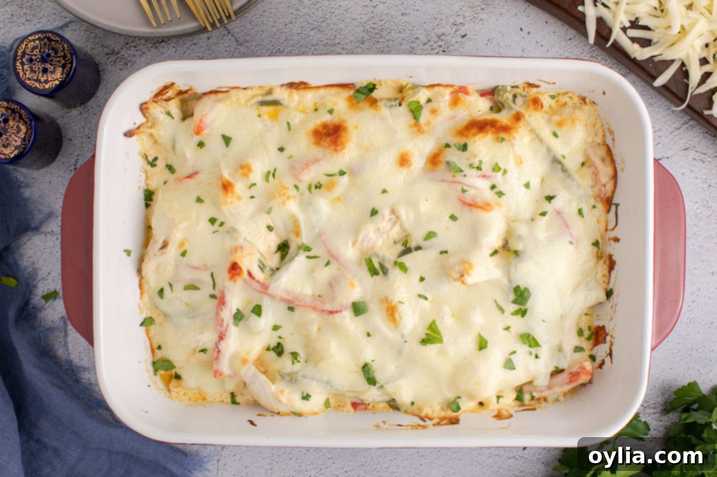 bubbly chicken philly cheesesteak casserole with chopped parsley as garnish, ready to serve