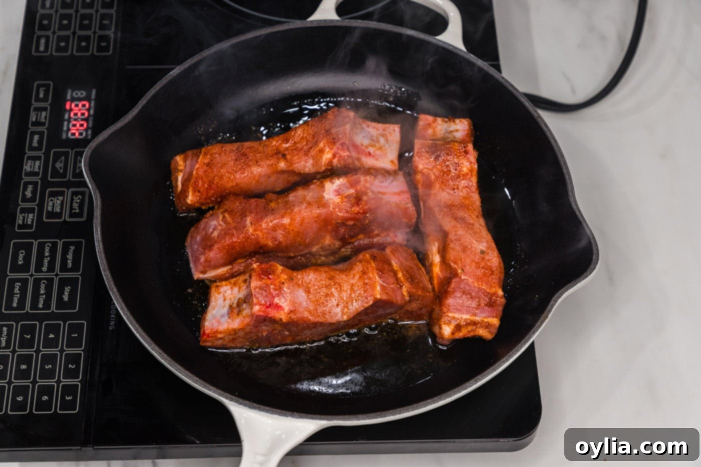 searing ribs in a skillet