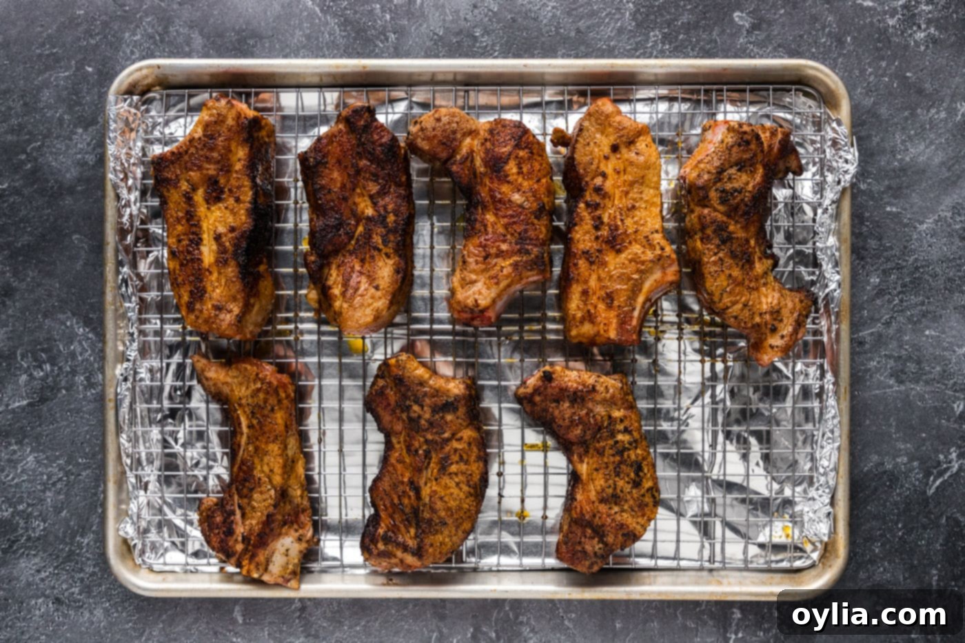 pork ribs on a wire rack over a baking sheet