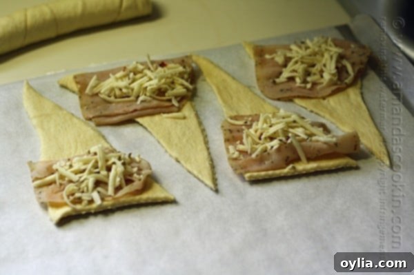 Step-by-step: adding turkey and cheese to crescent roll dough triangles