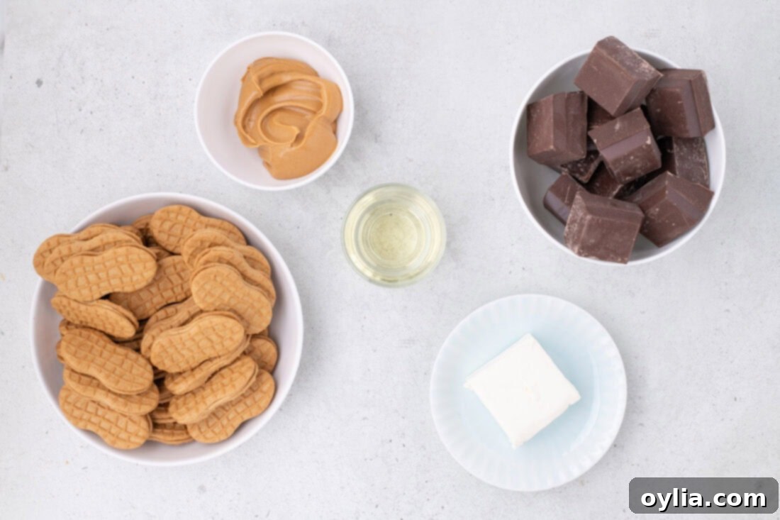 All the necessary ingredients for Nutter Butter Balls laid out on a surface.