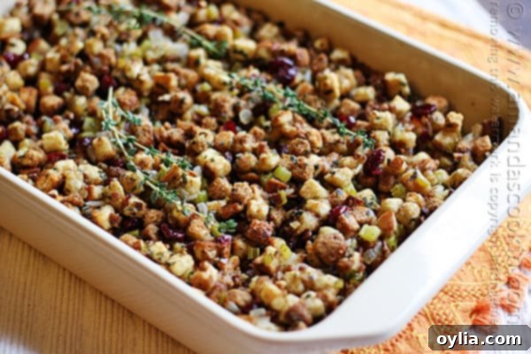 A close up of a pan of golden-brown stuffing, rich with herbs.