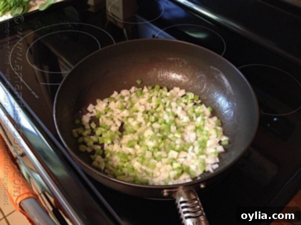 Chopped onion and celery simmering in melted butter in a large skillet.