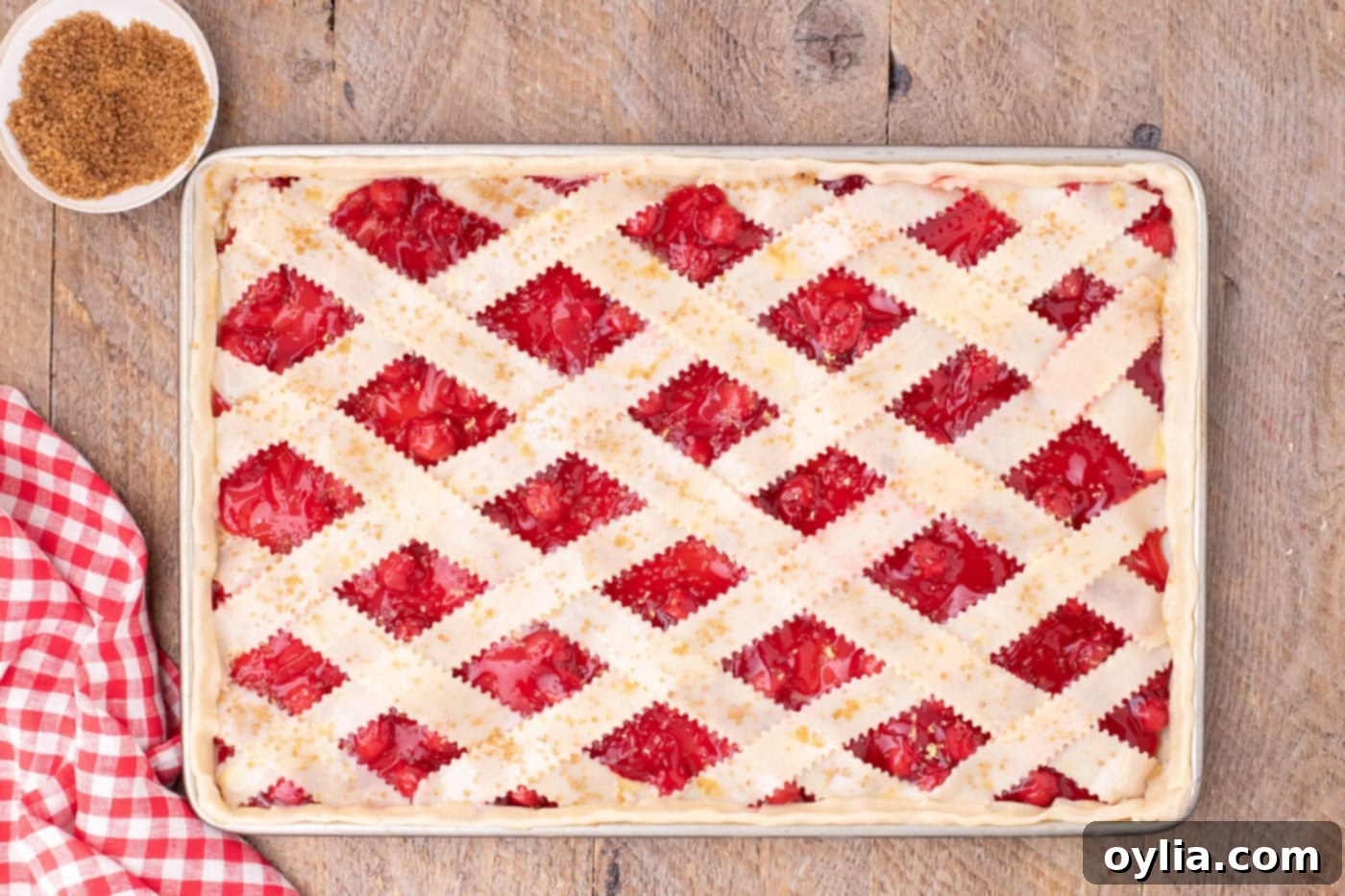 Turbinado sugar generously sprinkled over the unbaked lattice-top slab pie, creating a beautiful sparkle before baking.