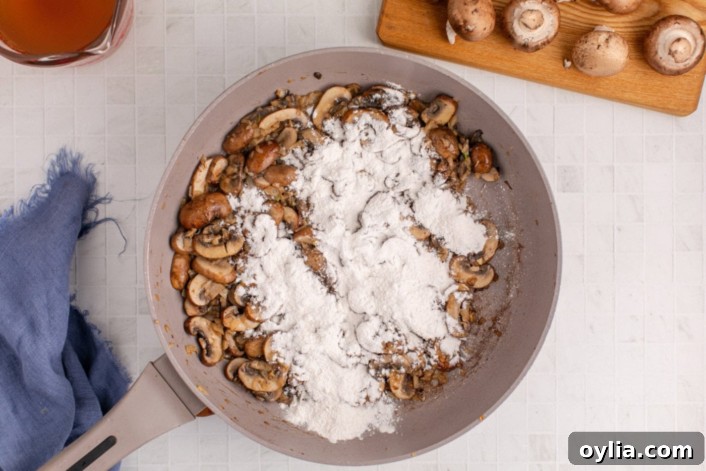 Flour sprinkled over the cooked onion and mushrooms in the skillet to create a roux