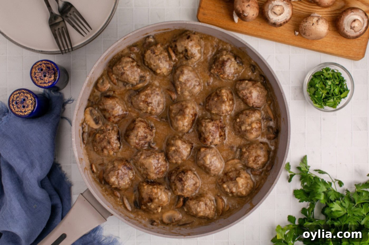 Finished dish of Salisbury Steak Meatballs coated in rich mushroom gravy in a skillet, ready to be served