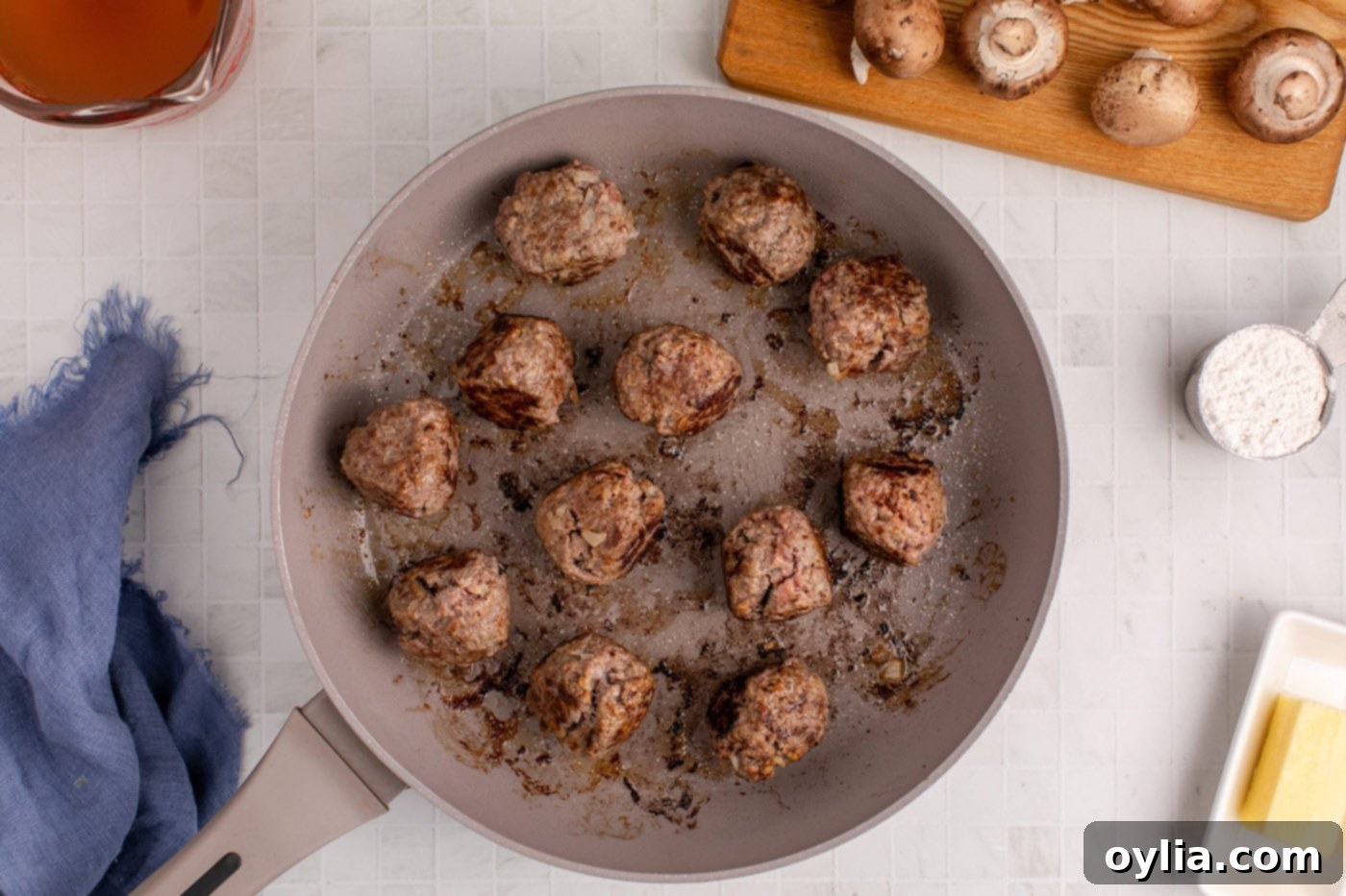 Cooking batches of Salisbury Steak Meatballs in a hot skillet until perfectly browned