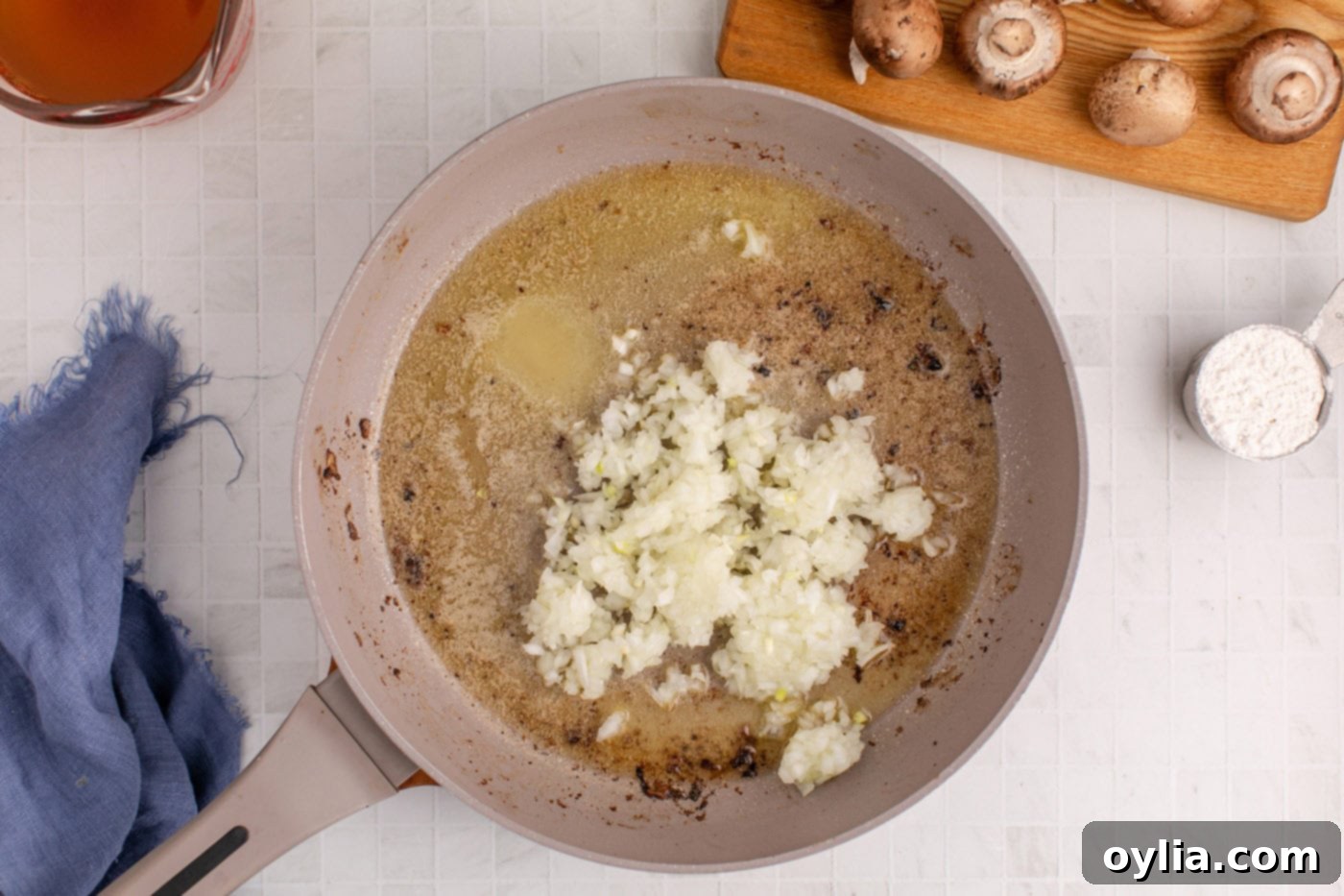 Chopped onion cooking in melted butter in a skillet, building the gravy base