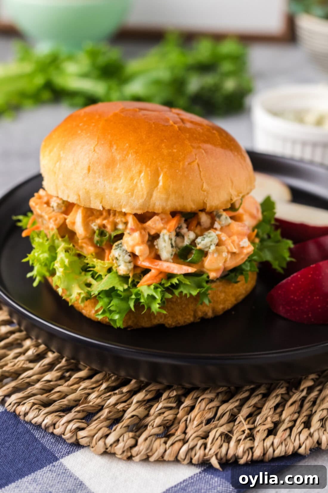 Buffalo Chicken Salad 9 Buffalo Chicken Salad served on a soft hamburger bun, garnished with fresh lettuce.