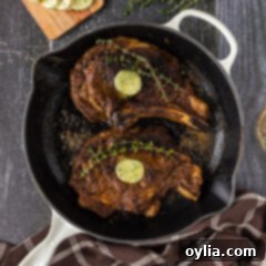 Two Bone in Ribeyes in a skillet, ready to be served.