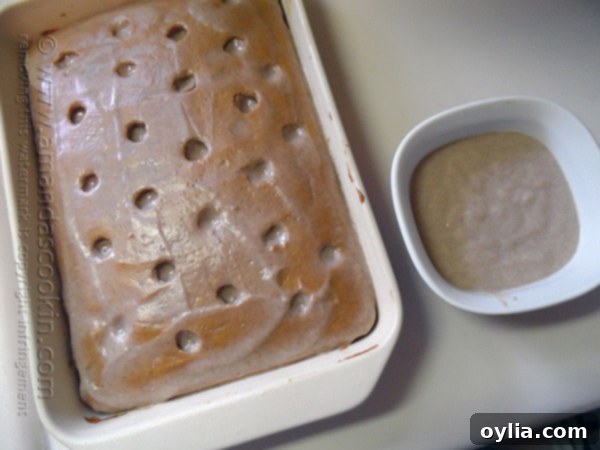 An overhead photo of pumpkin cake in a baking dish with pudding on top.