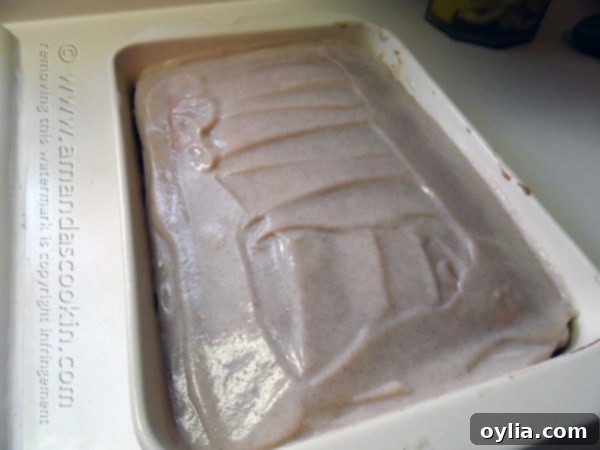 An overhead photo of pumpkin cake in a baking dish pudding spread over the top.