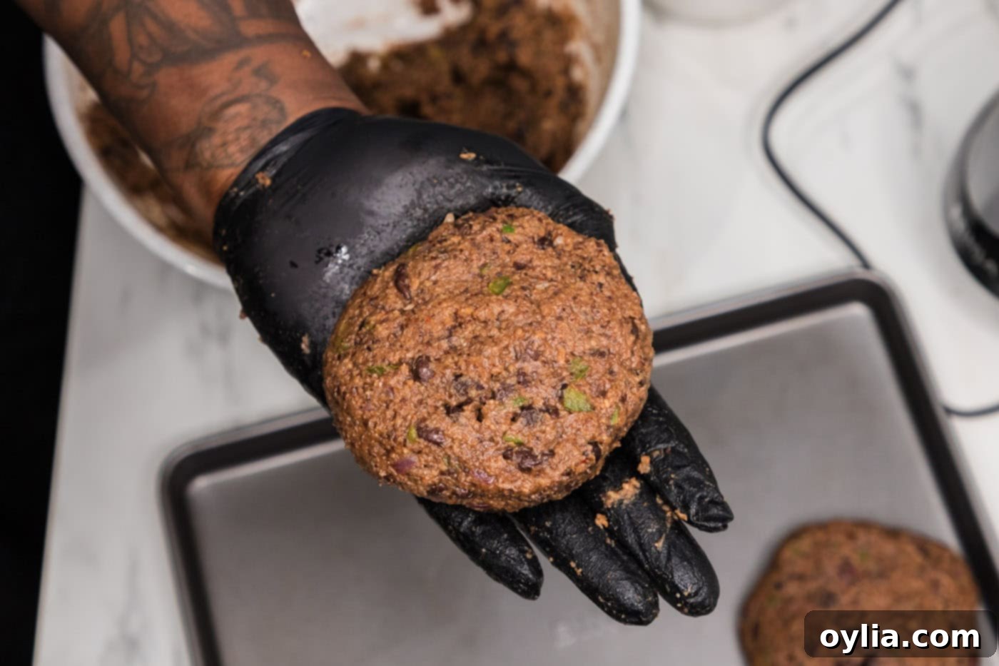 hand holding black bean burger patty