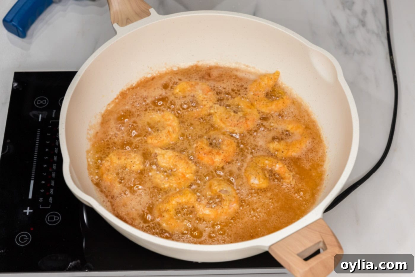 fried shrimp in a skillet with oil