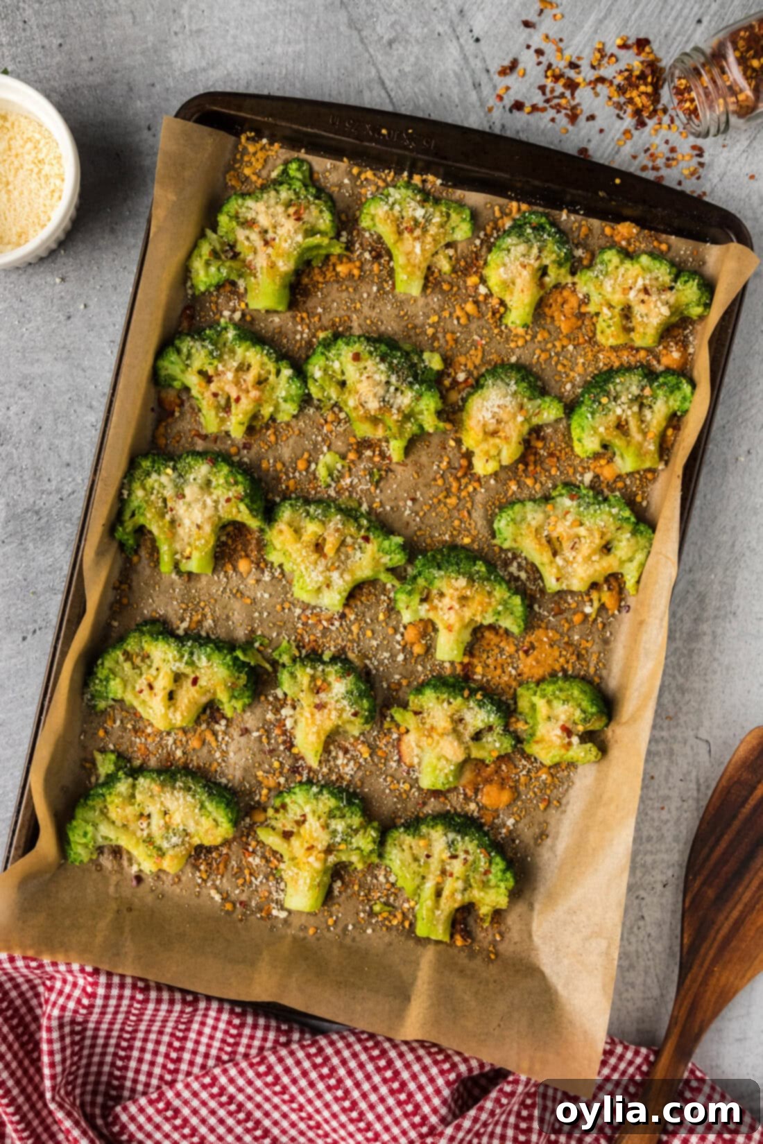 Smashed Broccoli on a sheet pan, hot out of the oven, garnished and ready to serve.