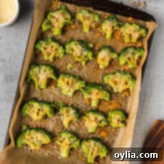 Smashed Broccoli on a parchment lined baking sheet, ready for the oven