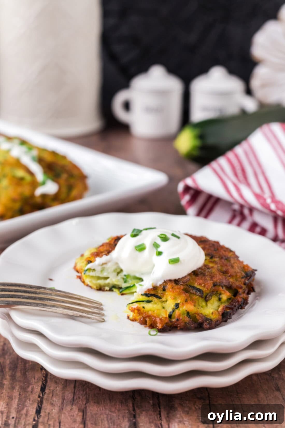 Zucchini Fritter on a plate with a piece removed