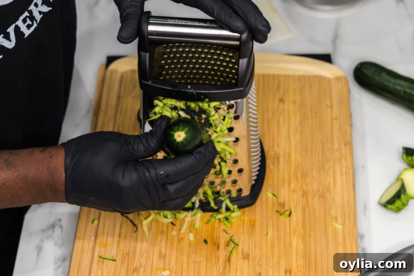 shredding zucchini on a box grater
