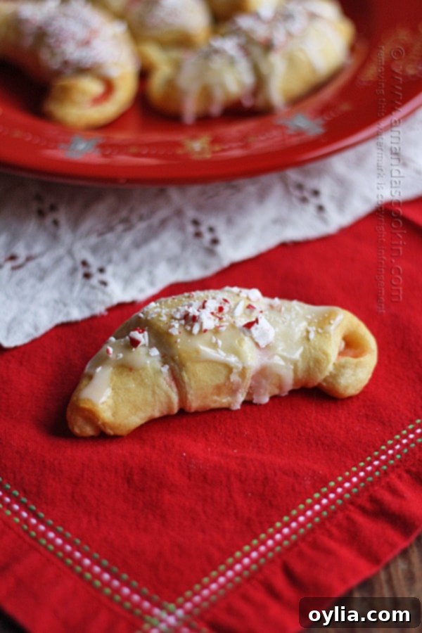 A close up photo of a white chocolate candy cane crescent on a red napkin.