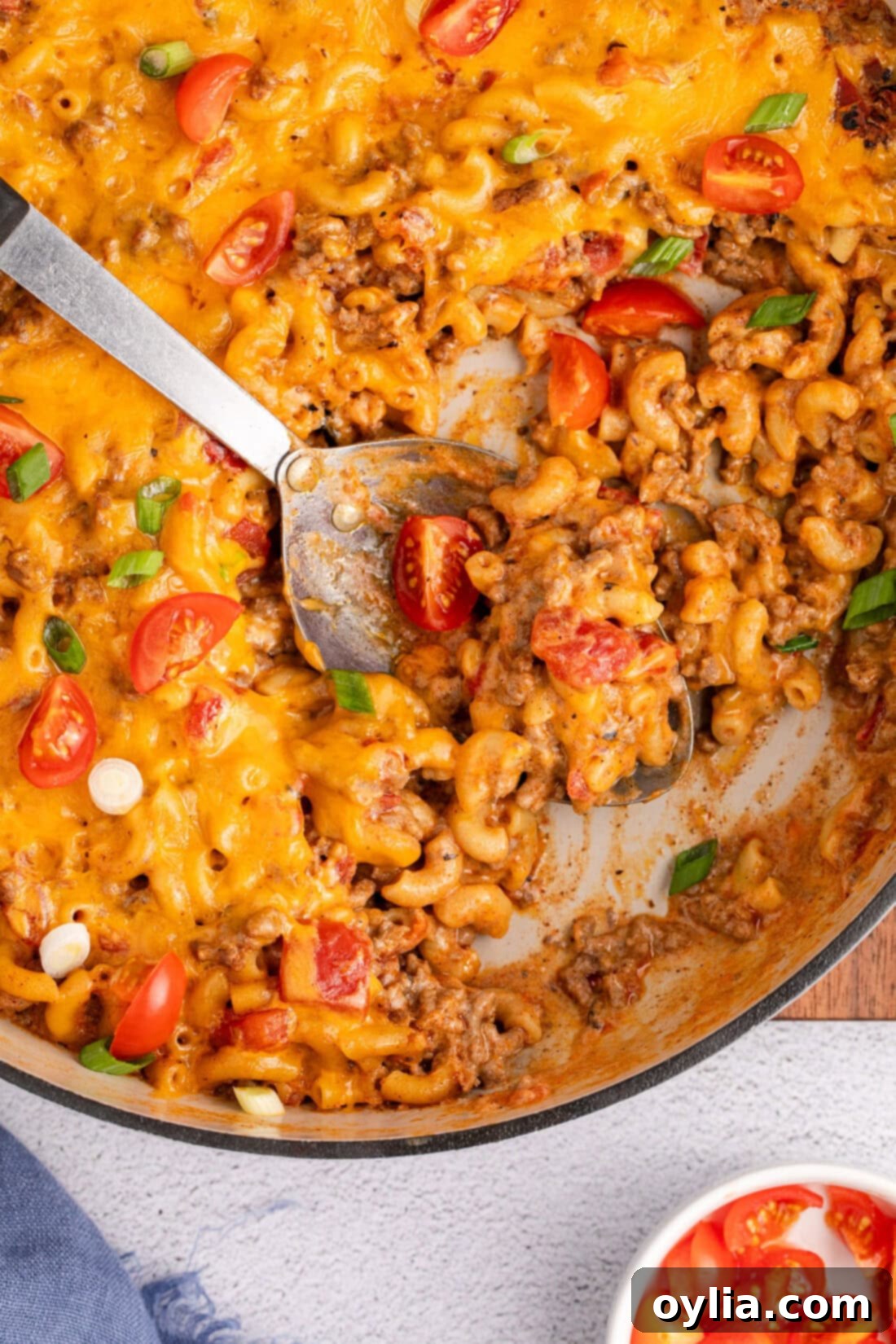Close up photo of a spoon in a skillet of Taco Macaroni and Cheese