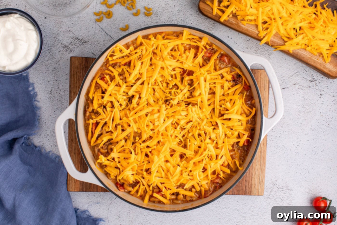 shredded cheddar cheese on top of taco mac