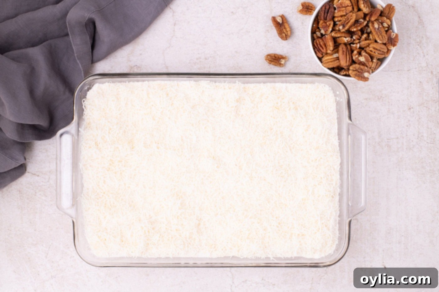 Shredded coconut spread on top of the dry cake mix layer