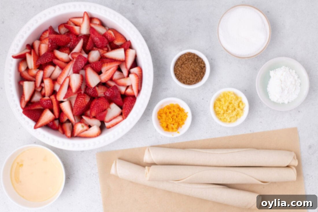 Collection of fresh ingredients for Strawberry Slab Pie including strawberries, pie crusts, sugar, cornstarch, and citrus.
