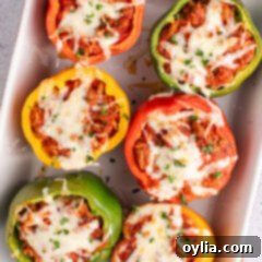 Hearty Turkey Pepper Boats 12 Turkey Stuffed Peppers in a baking dish with melted cheese, ready to serve.