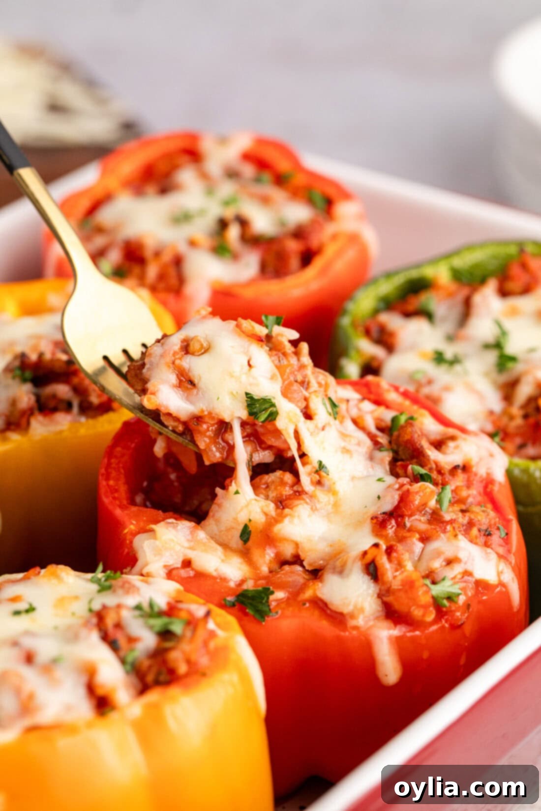 Hearty Turkey Pepper Boats 3 Fork picking up a spoonful of the flavorful turkey and rice filling from a cooked Turkey Stuffed Pepper.