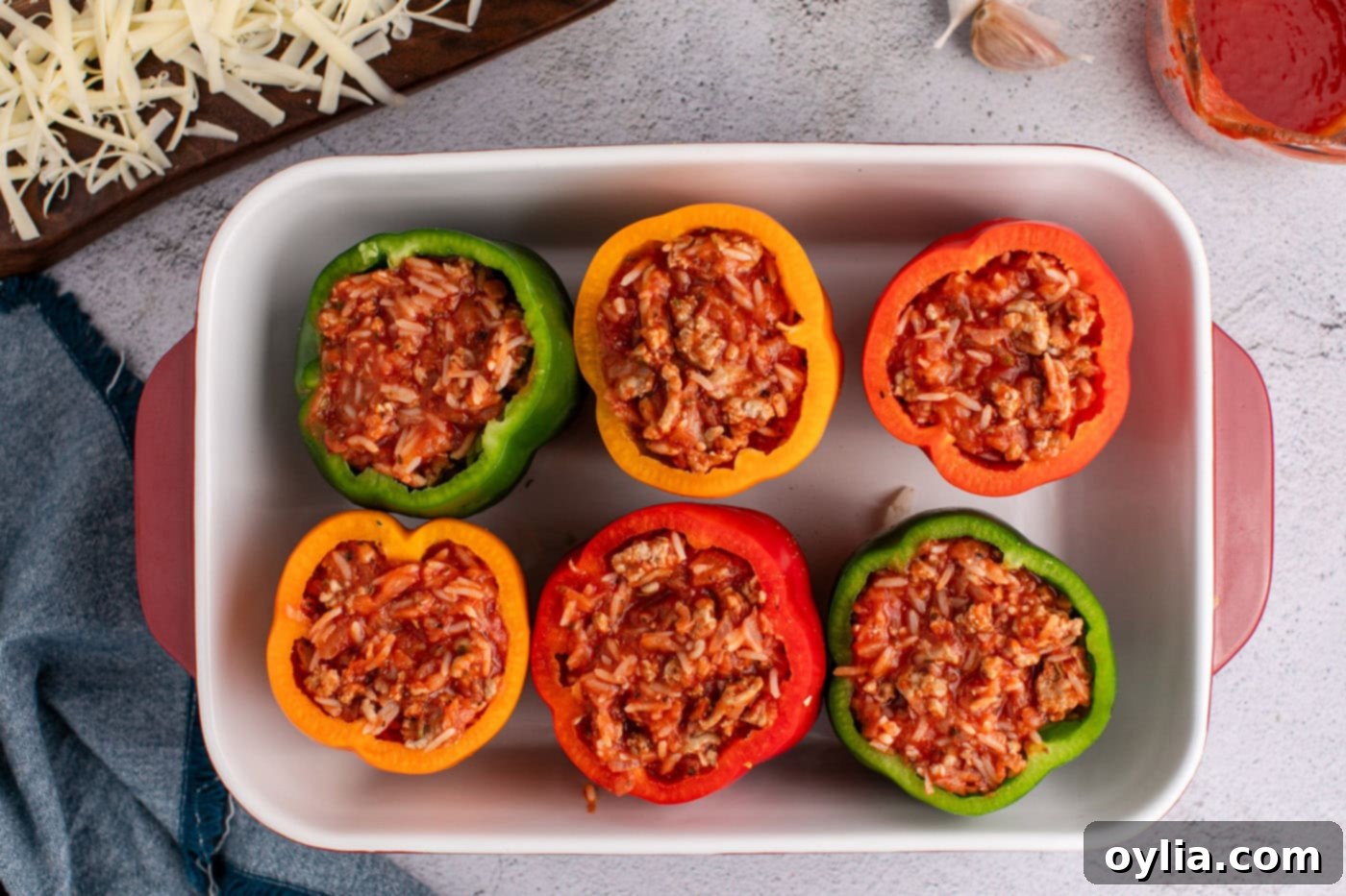 Bell peppers in a casserole dish generously filled with the savory rice and turkey mixture.