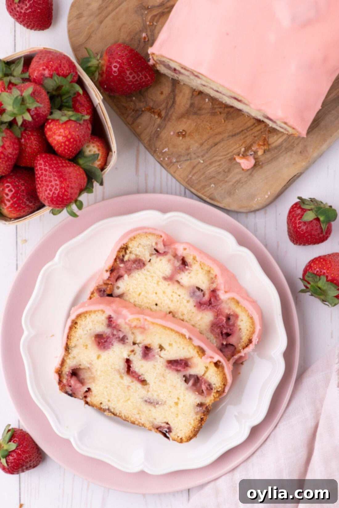 Two slices of Strawberry Pound Cake on a plate, garnished and ready to eat.