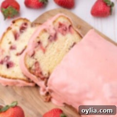 Close-up of a slice of Strawberry Pound Cake, showing the moist crumb and juicy berries.