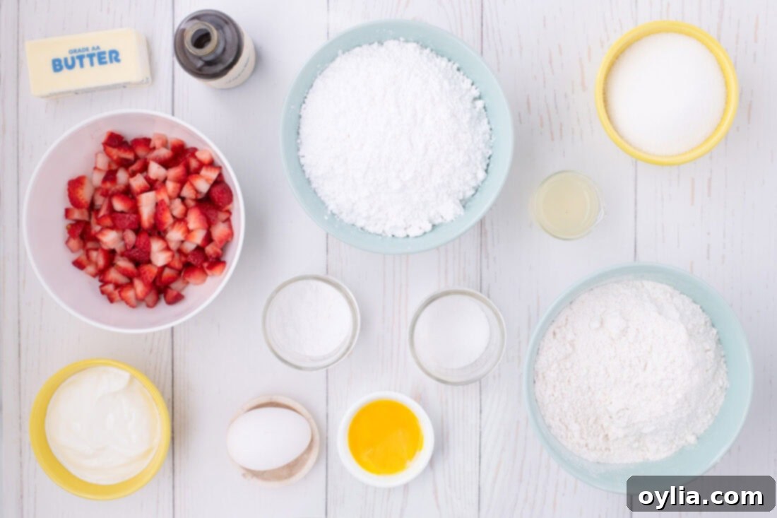 Ingredients for Strawberry Pound Cake laid out on a table, including fresh strawberries, flour, butter, and eggs.