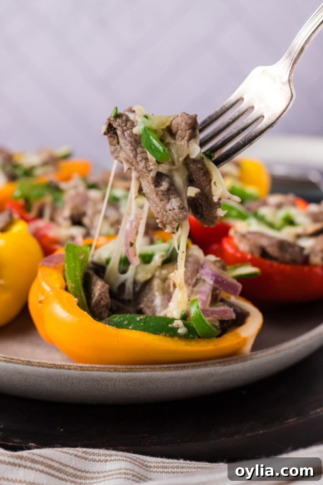 Fork pulling up pieces of Philly Cheesesteak Stuffed Peppers