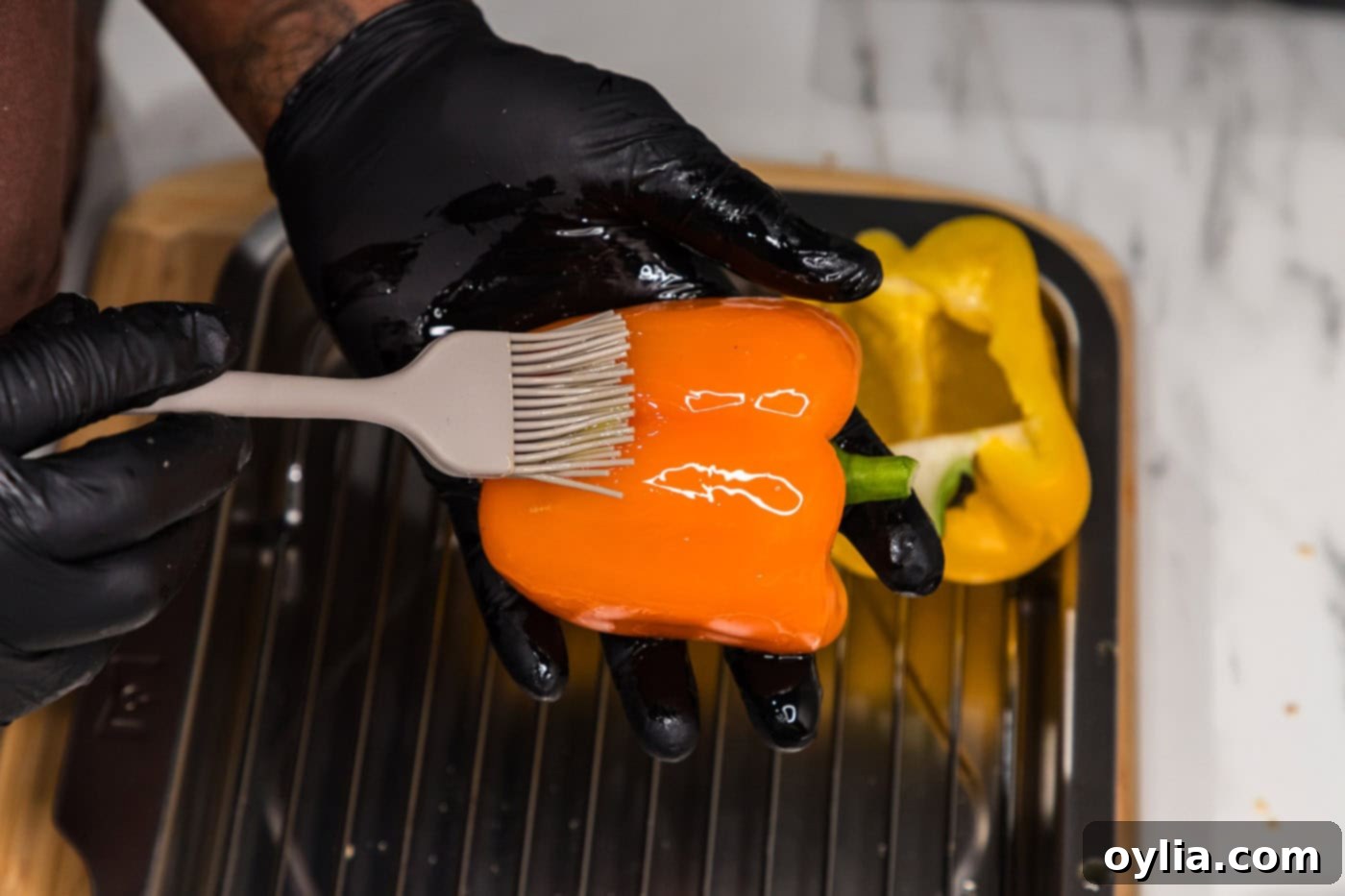 brushing bell pepper halves with olive oil before baking