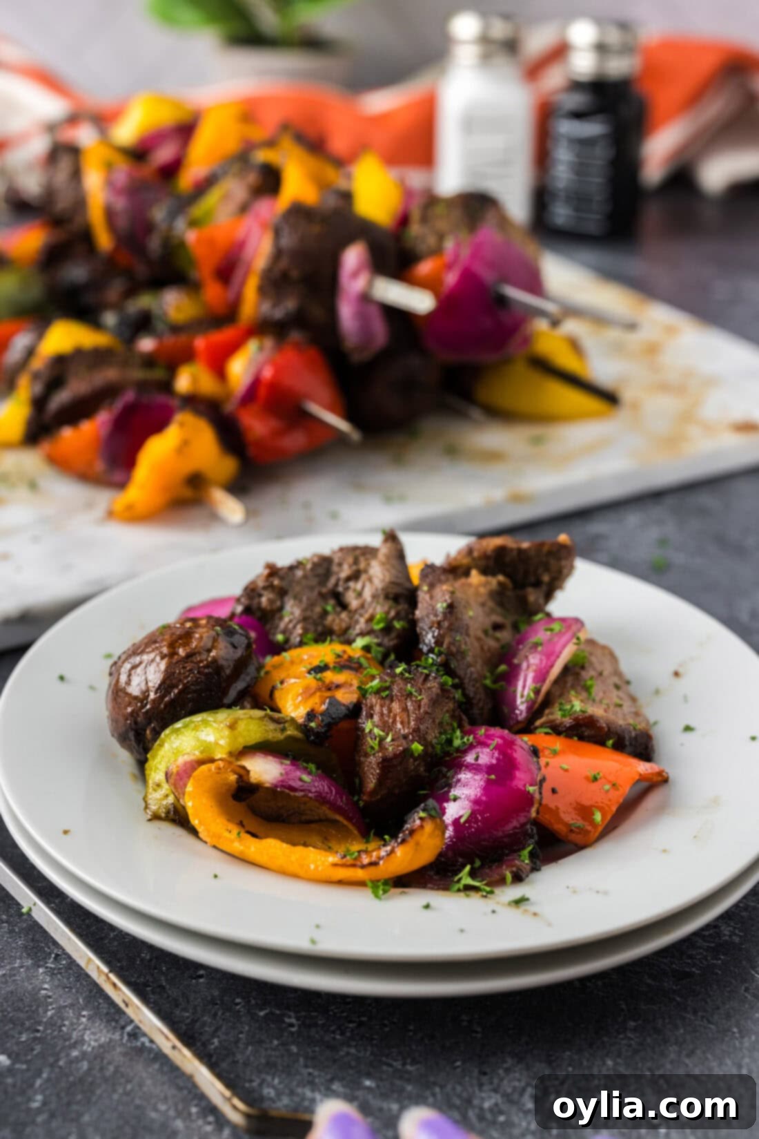 Ultimate Steak Kabobs 3 Disassembled Steak Kabob on a plate with more Steak Kabobs in the background