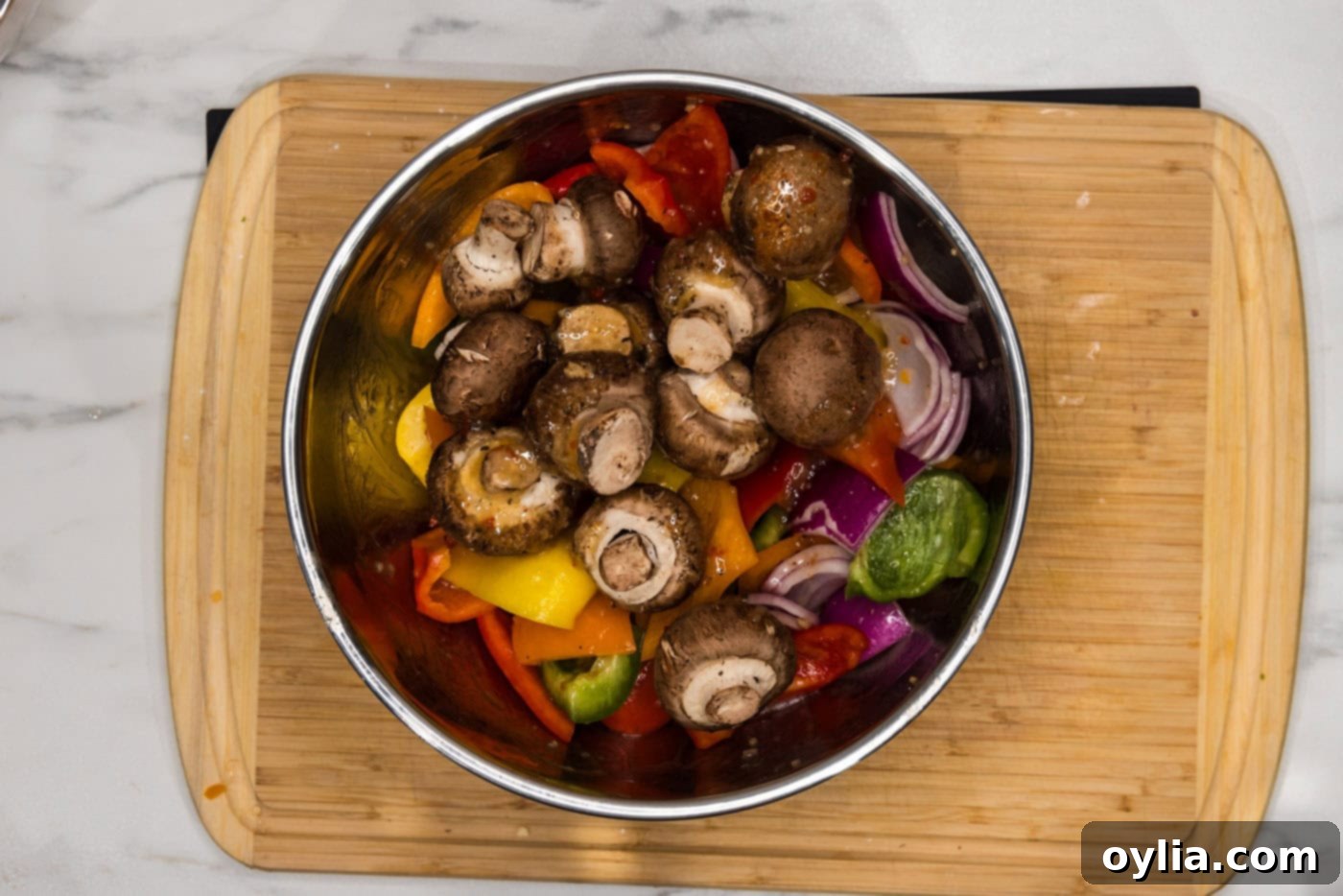 bowl of sliced bell peppers, onions, and mushrooms