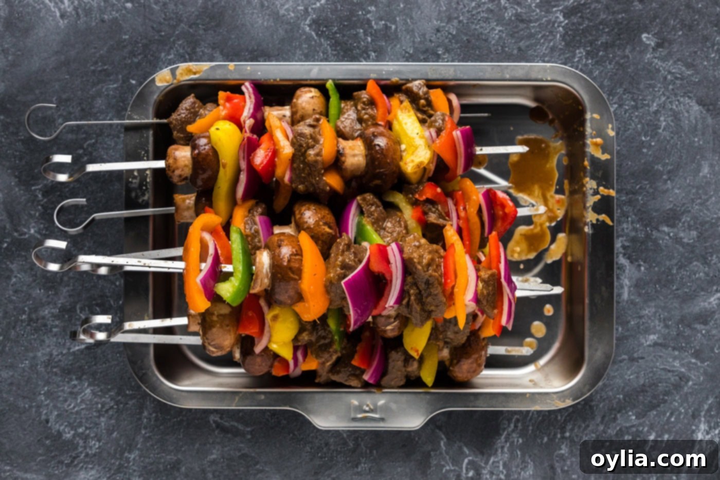 steak kabobs skewered with bell peppers, onions, and mushrooms