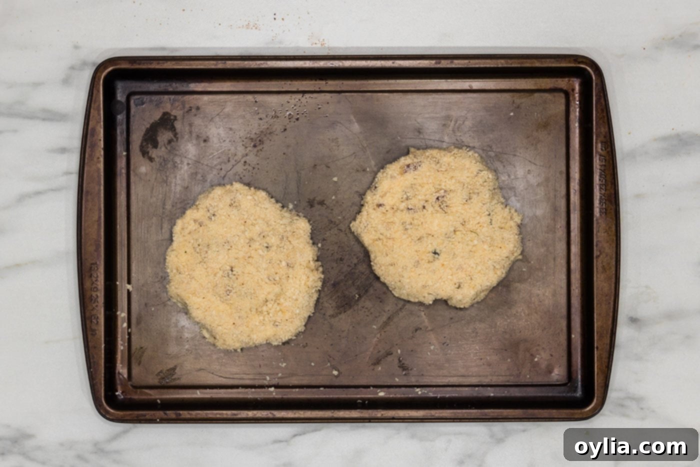 shrimp burger patties on a baking sheet