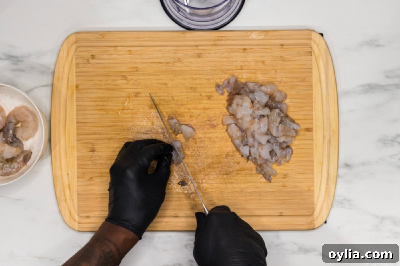hand chopping raw shrimp