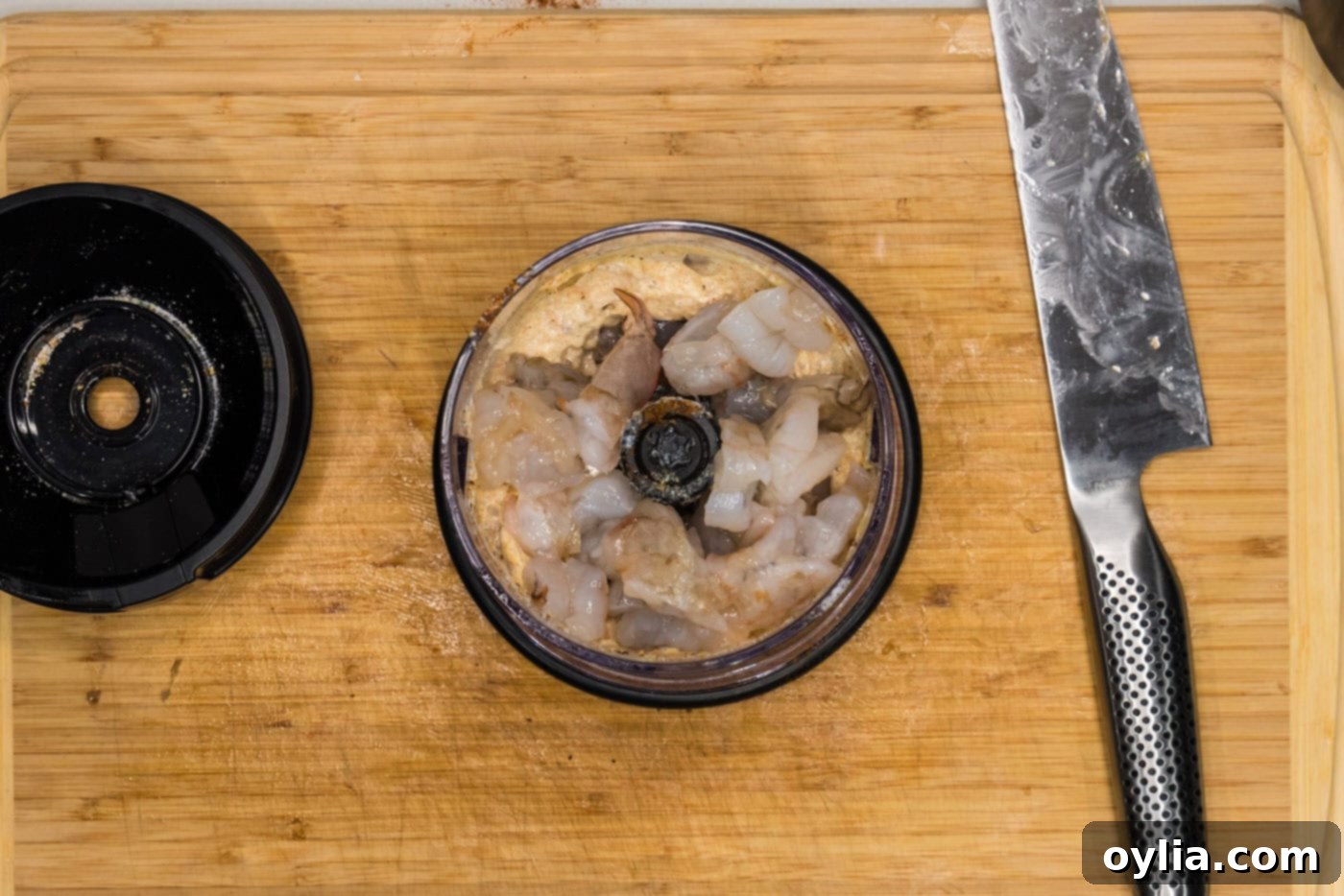 shrimp added to burger ingredients in a mini chopper