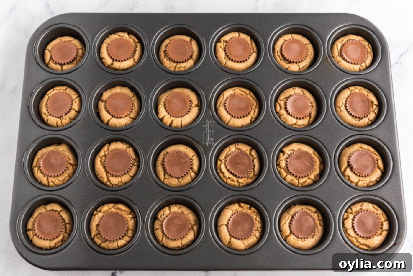 baked reeses peanut butter cup cookies in a mini muffin pan