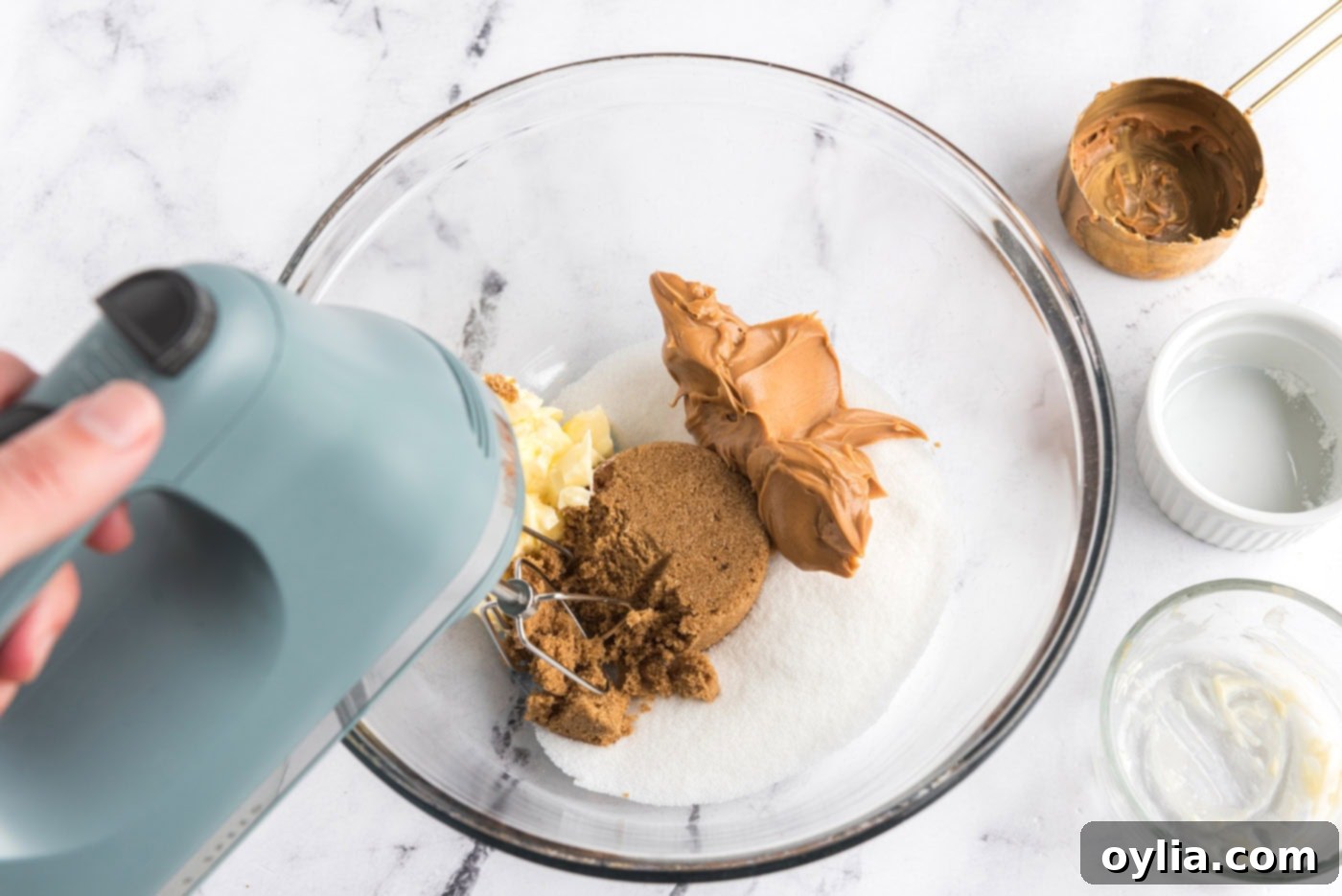 peanut butter, sugar, brown sugar, and butter in a mixer bowl